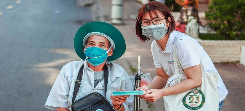 Woman from Trung Son Pharmacy gives help to elder person in Vietnam
